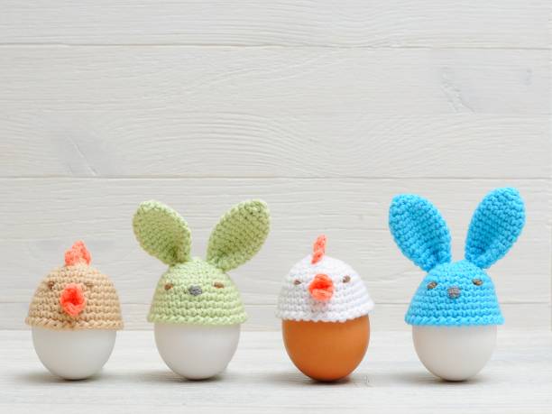 istock Easter holiday eggs with bunny ears on white wooden table. Easter ideas 936543566