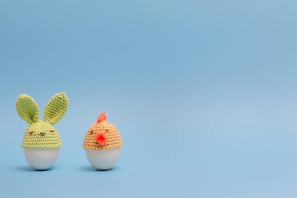 istock Funny bunnies easter eggs. Holidays decoration on  blue background. Easter ideas 936543596