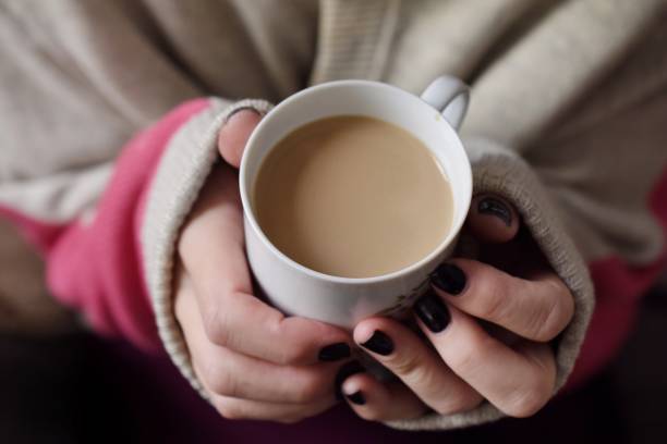 istock Midsection Of Woman Holding Tea Cup 936543860