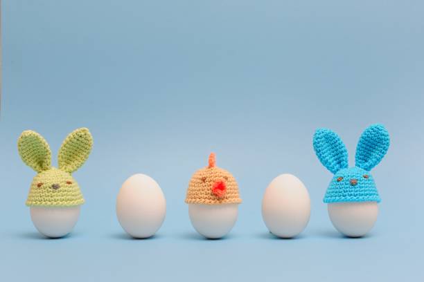 istock Funny bunnies easter eggs. Holidays decoration on  blue background. Easter ideas 936543896