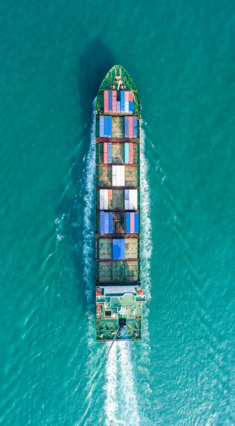 istock Container ship in export and import business and logistics. Shipping cargo to harbor by crane. Water transport International. Aerial view 936548252
