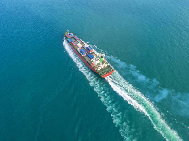 istock Container ship in export and import business and logistics. Shipping cargo to harbor by crane. Water transport International. Aerial view 936548276