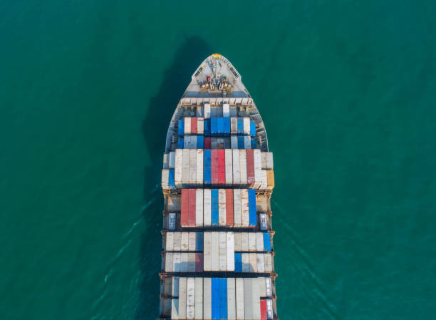 istock Container ship in export and import business and logistics. Shipping cargo to harbor by crane. Water transport International. Aerial view 936548304