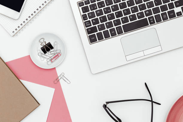 istock Feminine business desk from above on white background 936551406