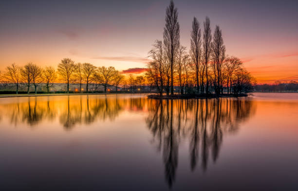 Pontefract Park Lake near Wakefield, sunrise reflections near Pontefract Racecourse, West Yorkshire, UK