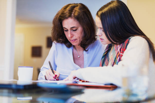 istock Mother and daughter reviewing important financial documents together 936553592