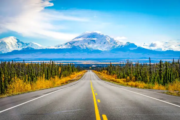 Alaska road with mountain and blue sky