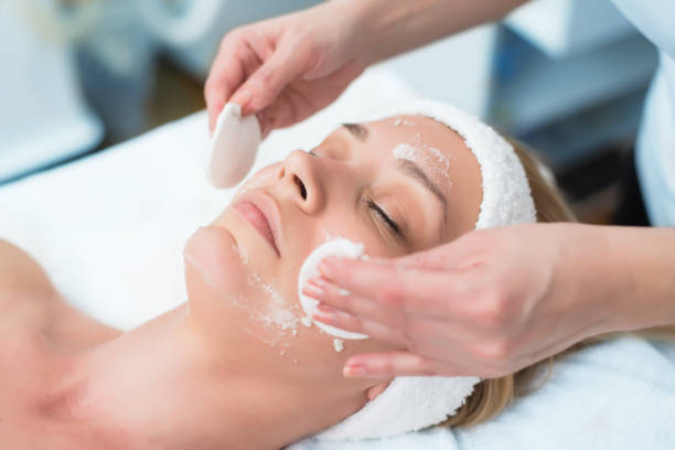 Picture of a person receiving facial exfoliation Picture of a person receiving facial exfoliation scrubbing stock pictures, royalty-free photos & images