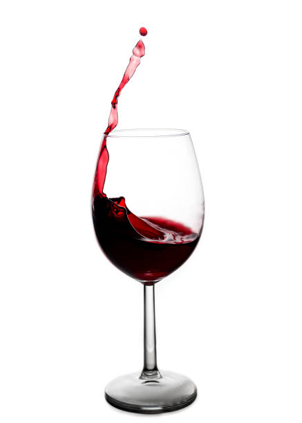 istock splash of red wine in a glass on a white background. 936560094