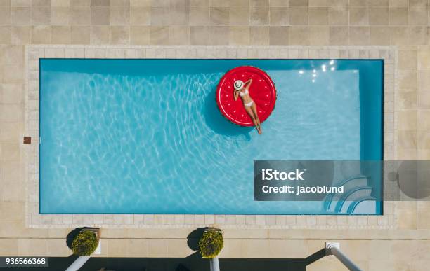 Woman Sunbathing On Inflatable Mattress In Pool Stock Photo - Download Image Now - Swimming Pool, Aerial View, Resort Swimming Pool