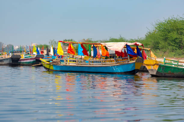 istock Colored wooden boats with flags in Mathura, India 936567852