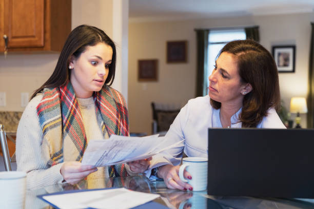 istock Mother and daughter arguing over utility bills 936584636