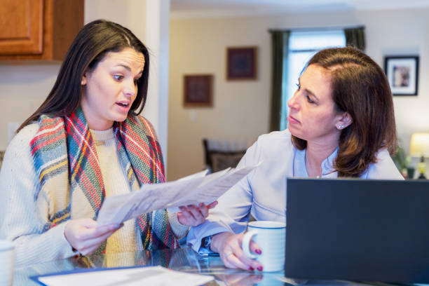 istock Mother and daughter arguing over utility bills 936587008