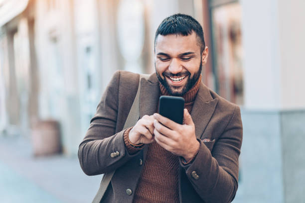 istock Middle-eastern ethnicity man with smart phone on the street 936587094