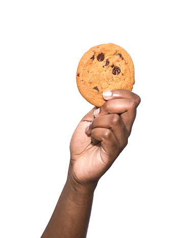African ethnicity holding chocolate chip cookie