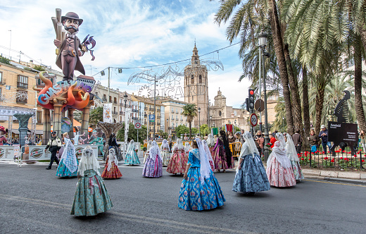 March 17, 2024 Valencia-Spain. Rear view of a group of women wearing traditional costume preparing for Las Fallas festivities in Valencia-Spain