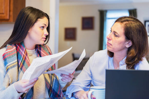 istock Mother and daughter arguing over utility bills 936588118