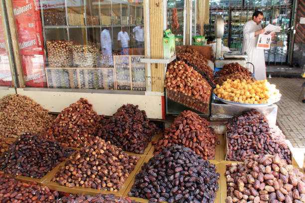 Dates trader on a market in the historic Al-Balad district of Jeddah, the Gate to Makkah, Kingdom of Saudi Arabia