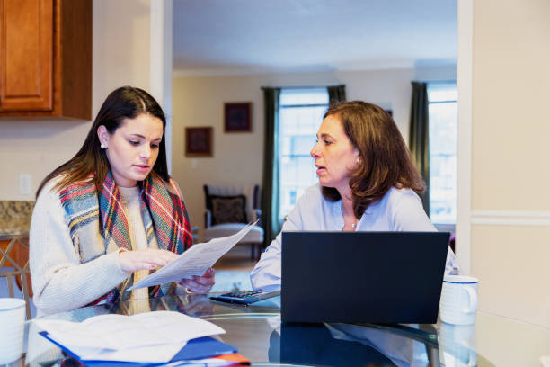 istock Mother and daughter arguing over utility bills 936594320
