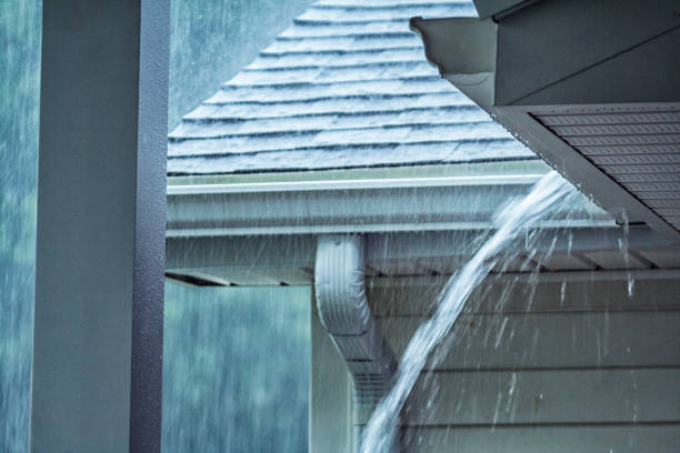 istock Drenching Rain Storm Water Overflowing Roof Gutter Close-up 936595120