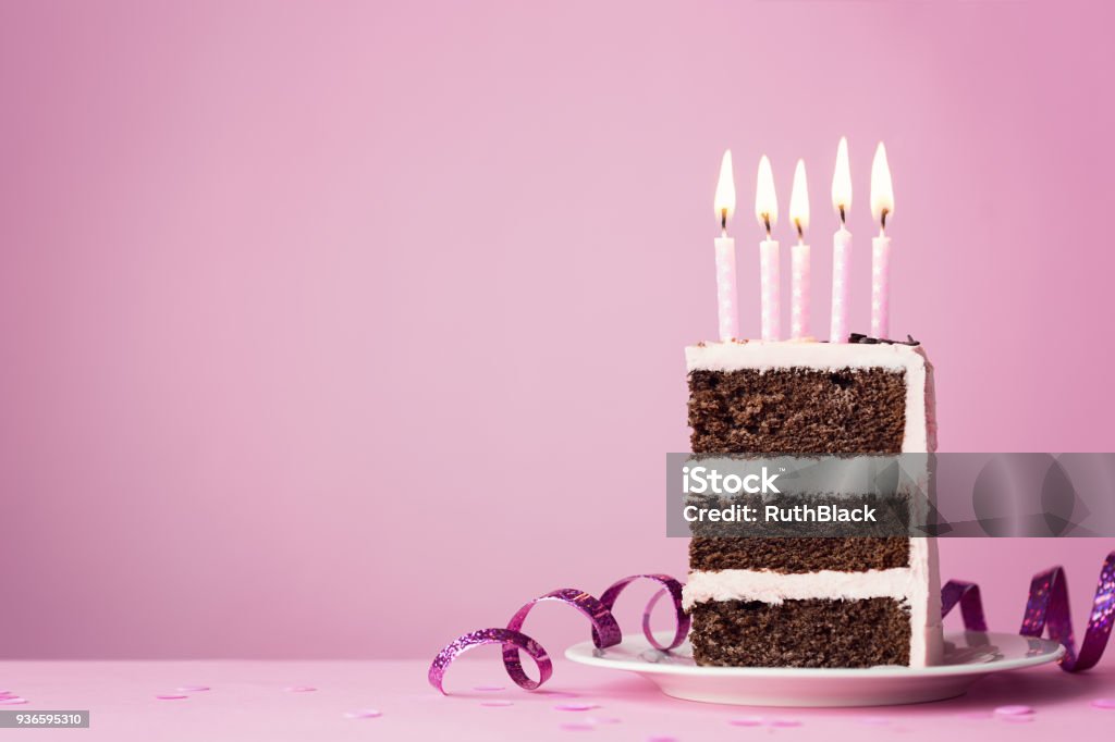 Chocolate birthday cake with pink candles Chocolate birthday cake with pink frosting and candles Birthday Stock Photo