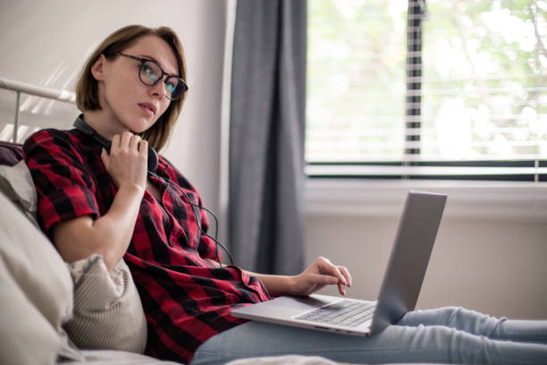 istock Cute girl working in bed 936598598