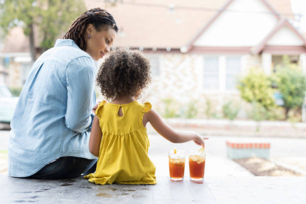 istock Mother and young daughter on front porch 936598676
