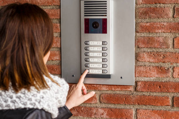 istock Woman pushing the button and talking on the intercom 936600168