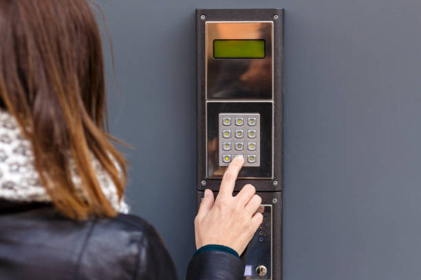 istock Woman pushing the button and talking on the intercom 936601288