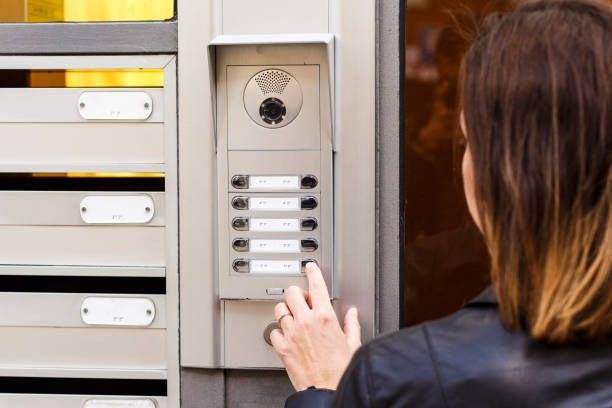 istock Woman pushing the button and talking on the intercom 936601676