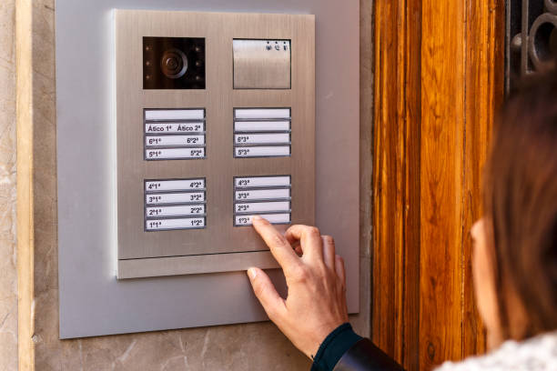 istock Woman pushing the button and talking on the intercom 936601682
