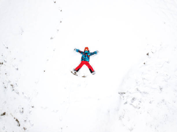 istock Winter aerial drone landscape with fun kid on snow 936602924
