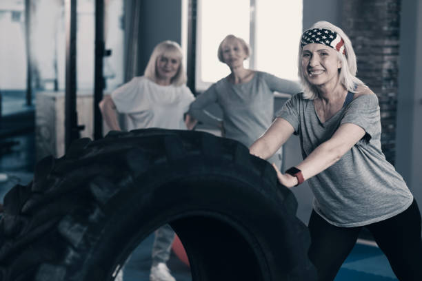 istock Personal trainer showing tire exercises to her clients 936603200