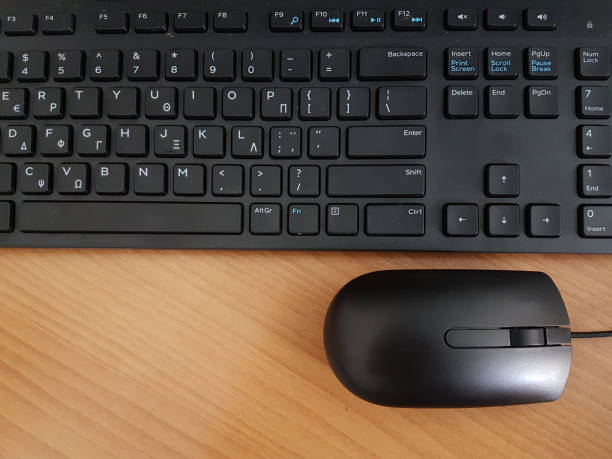 istock keyboard mouse black greek letters computer background - wood 936603334