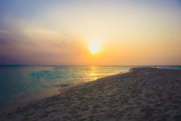 istock orange and blue beach sunset in Africa 936603850