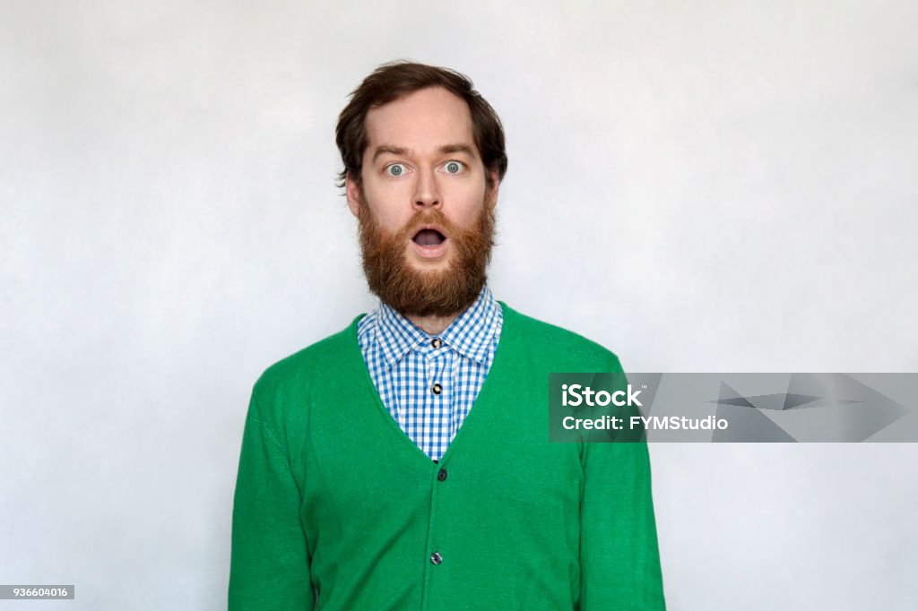 Shocked bearded man with open mouth Shocked man with thick ginger beard, isolated on gray Surprise Stock Photo