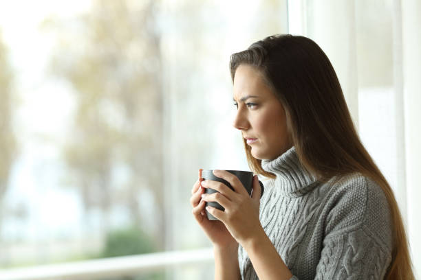 istock Angry woman looking through a window 936604092