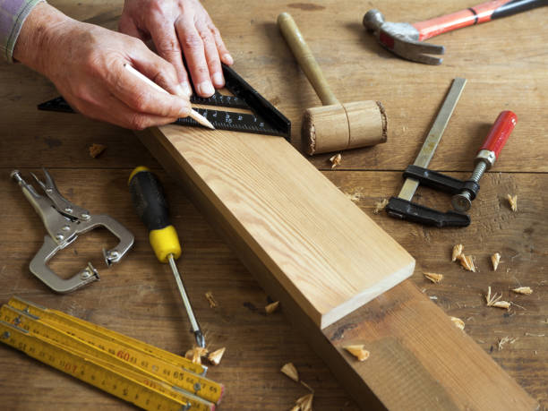 istock Carpenter measuring wooden board 936609822