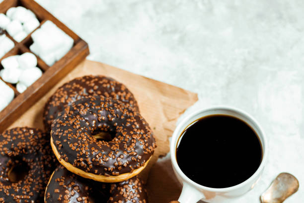 istock Chocolate donuts and coffee , weekend morning table breakfast. Vintage colors. 936614606