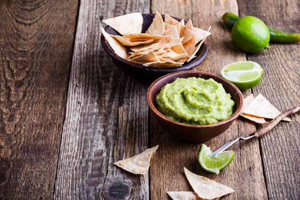istock Fresh guacamole dip with lime juice served with handmade nachos 936618090