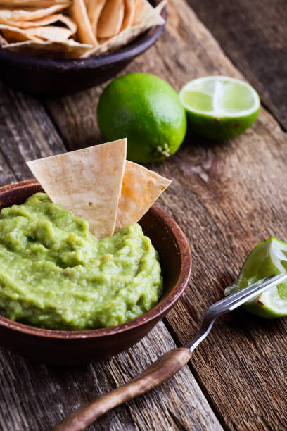 istock Fresh guacamole dip with lime juice served with handmade nachos 936618120