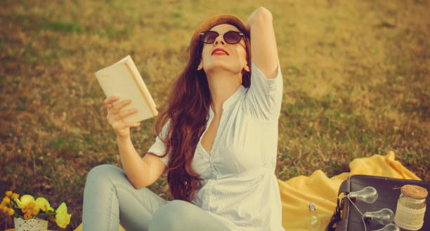 istock Young woman reading in the garden 936618942