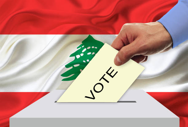 istock Man voting on elections in Lebanon front of flag 936621782
