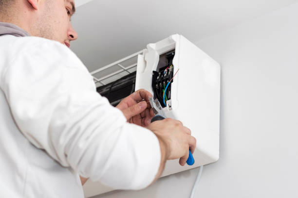istock Young man installing air conditioner in an apartment 936622330