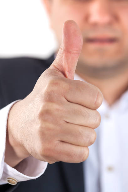 istock Happy businessman with thumbs up gesture, isolated on white 936622358