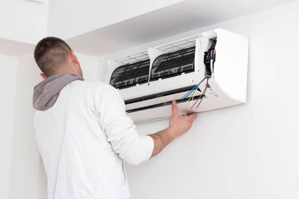istock Young man installing air conditioner in an apartment 936624710