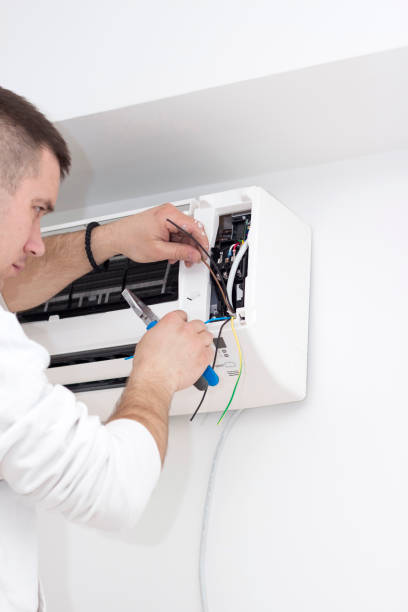 istock Young man installing air conditioner in an apartment 936624798