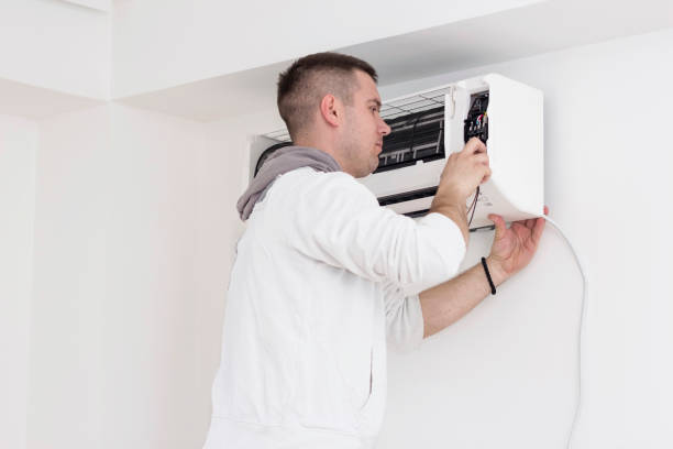 istock Young man installing air conditioner in an apartment 936624856