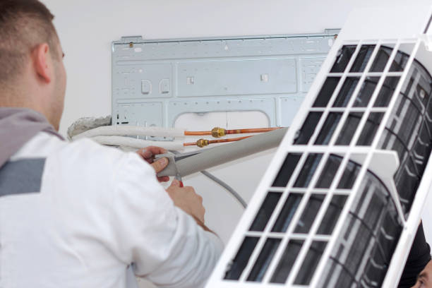 istock Young man installing air conditioner in an apartment 936625072
