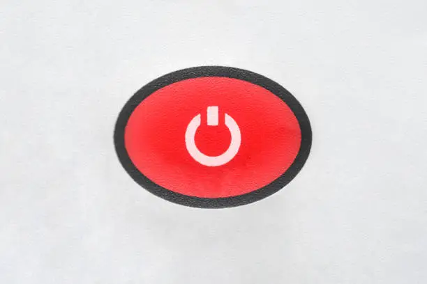 Photo of Red oval button power-up equipment close-up on a white background